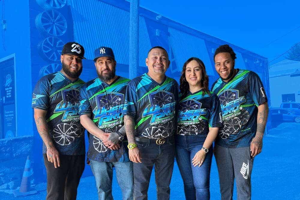 ProWheels Auto Repair team standing outside the shop in Bethlehem, PA, wearing branded uniforms